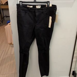 Size 10, waist 30, short. solid black jeans. Rips only at knees.